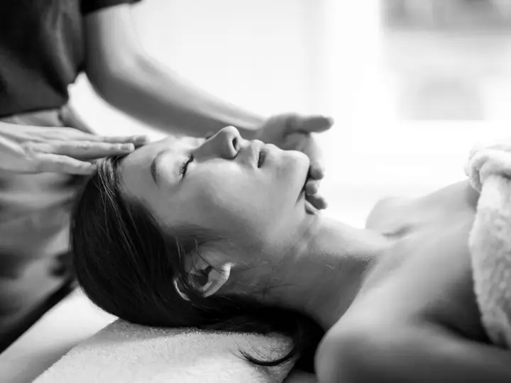 A woman receiving a head massage at a spa